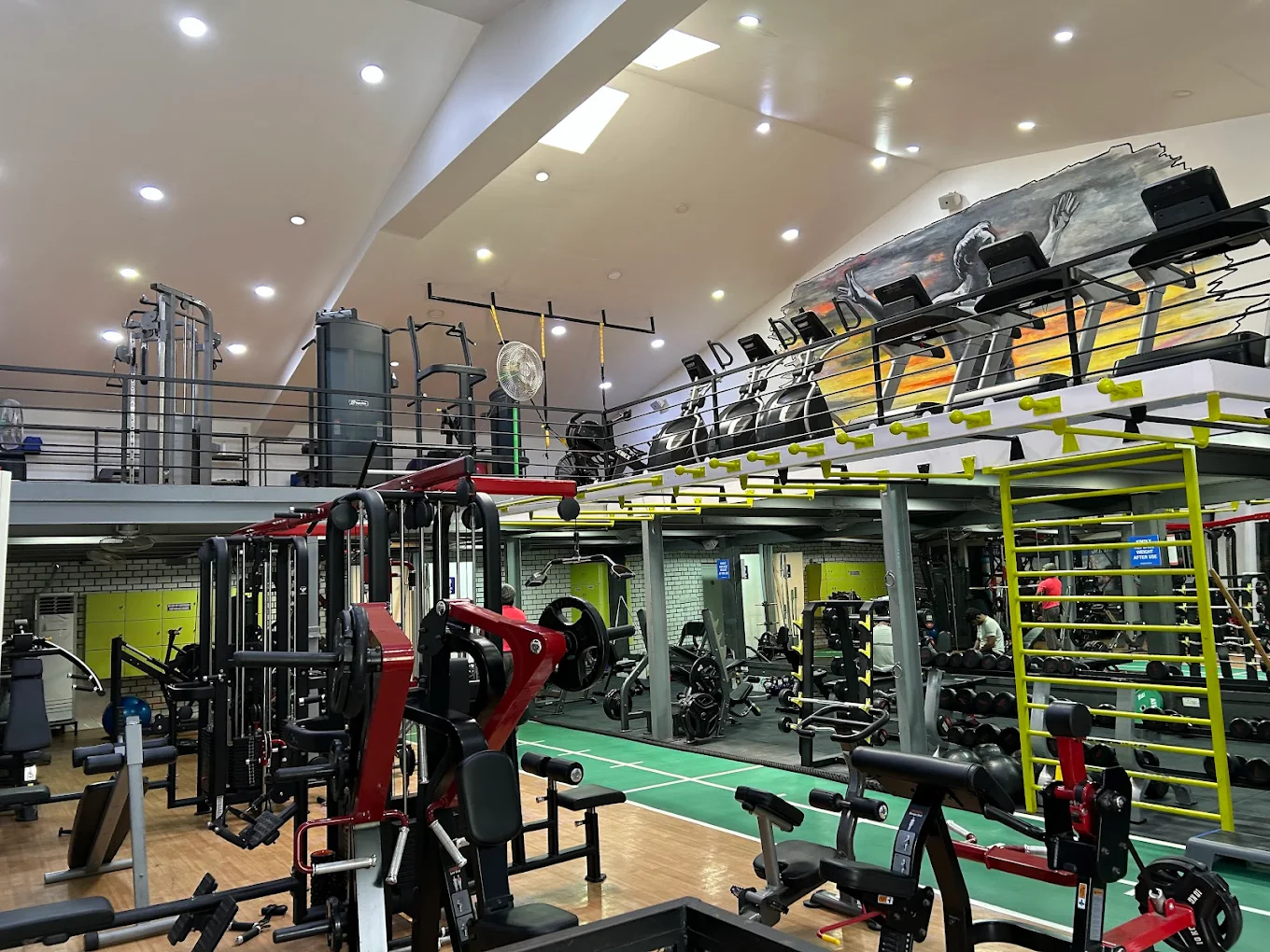 Modern fitness center with treadmills, weight machines, and floor-to-ceiling windows